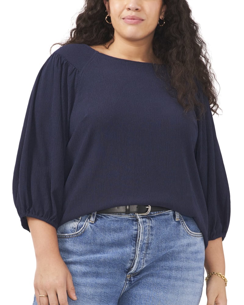 Front of a model wearing a size 1X Luna Puff Sleeve Knit Top in ARSTNG NAVY by Vince Camuto. | dia_product_style_image_id:260962